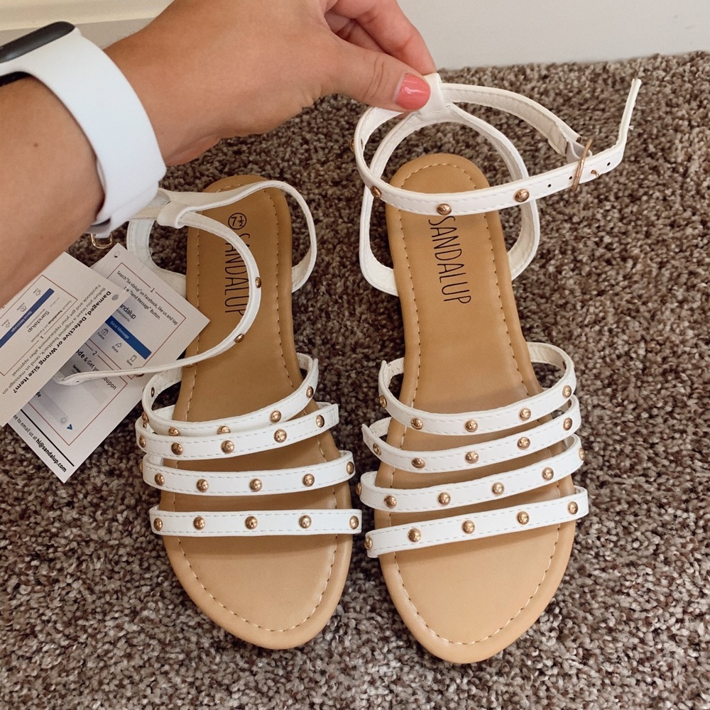 White sandals with gold detailing